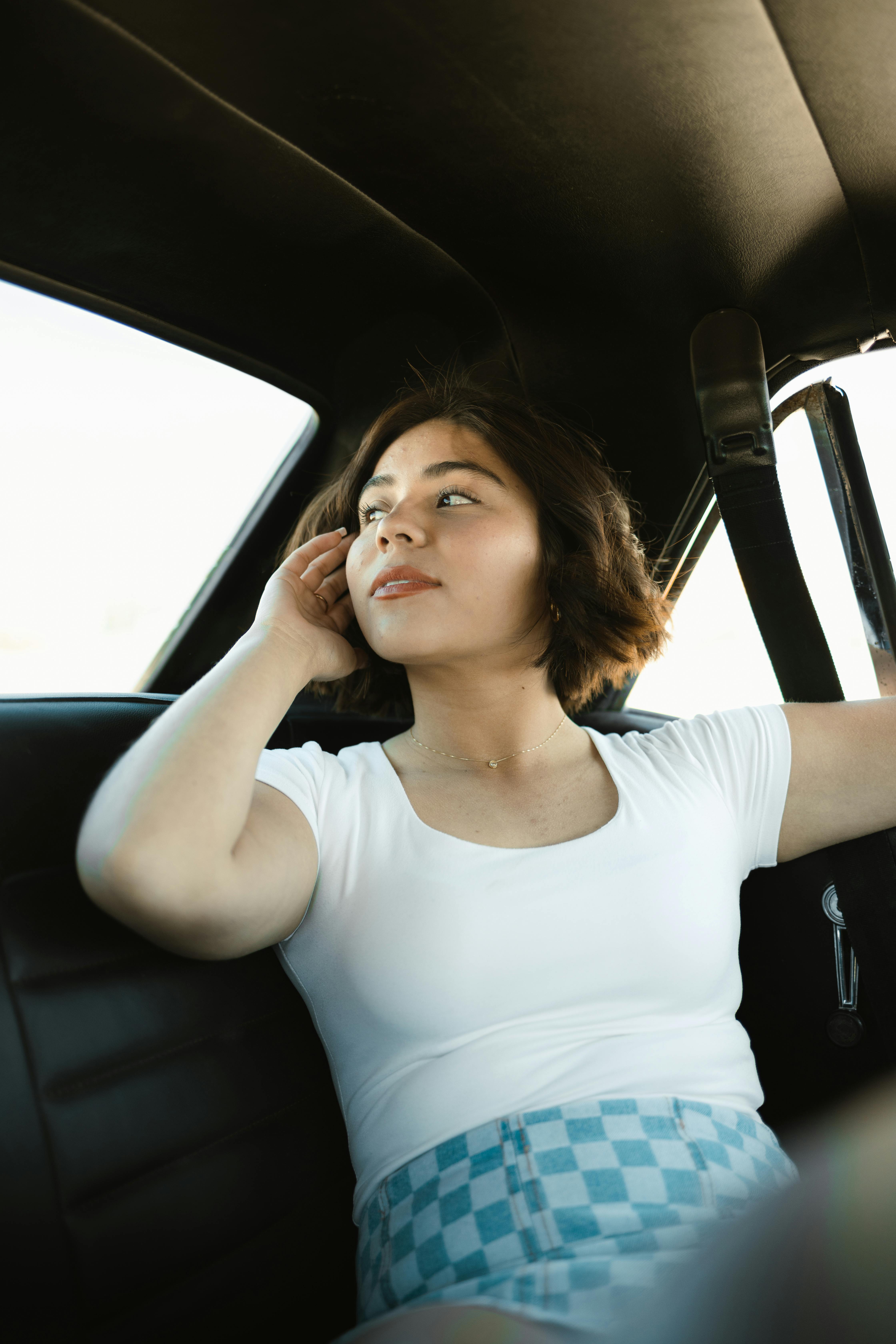 a woman sitting in the back seat of a car