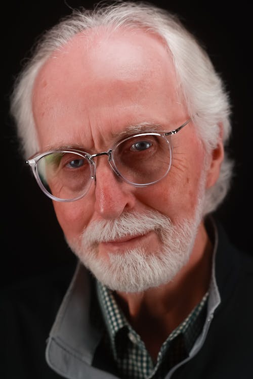 Man with Gray Hair and Beard Posing in Eyeglasses