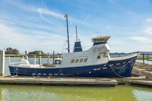 A Boat Moored in the Harbor under a Blue Sky 