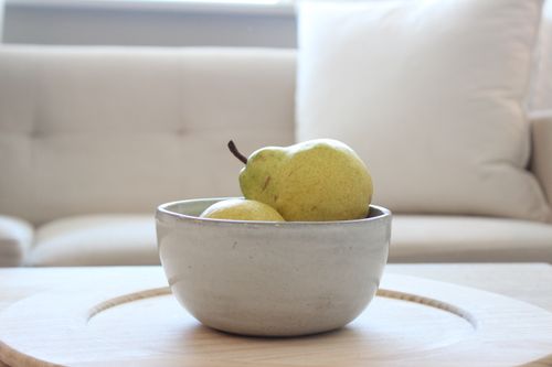 Free Elegant still life of pears in a ceramic bowl on a wooden table indoors. Stock Photo