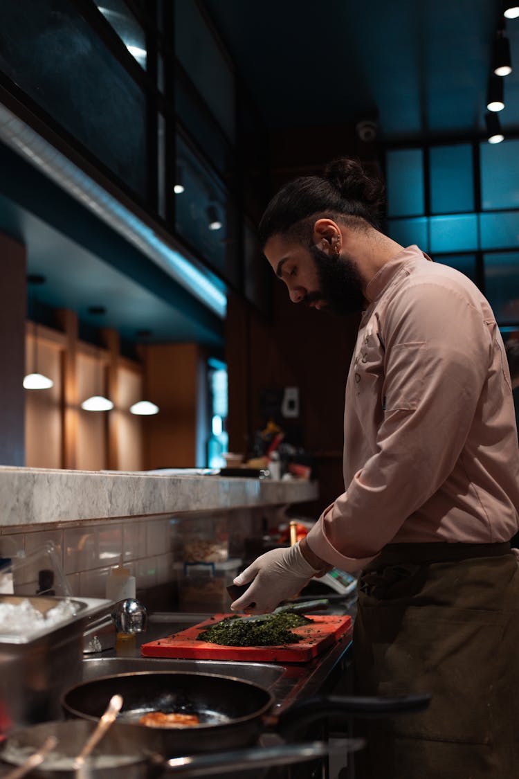 Man Working In The Kitchen With A Cutting Board