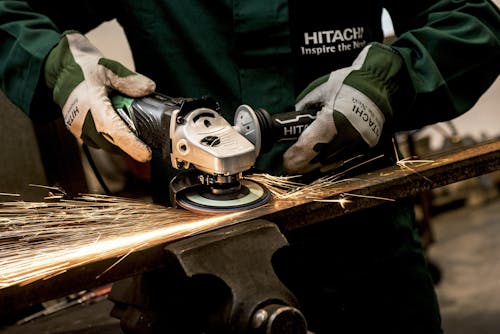 Free Person Holding Black and Gray Hitachi Angle Grinder Stock Photo