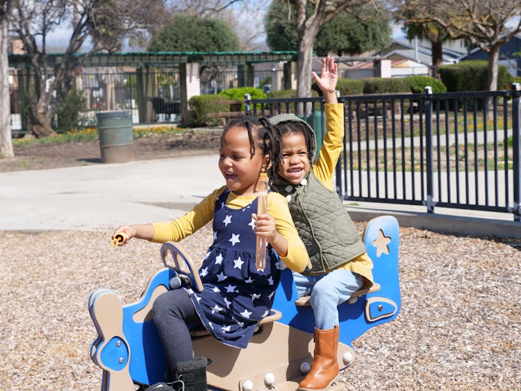 Two Little Girls On The Playground 