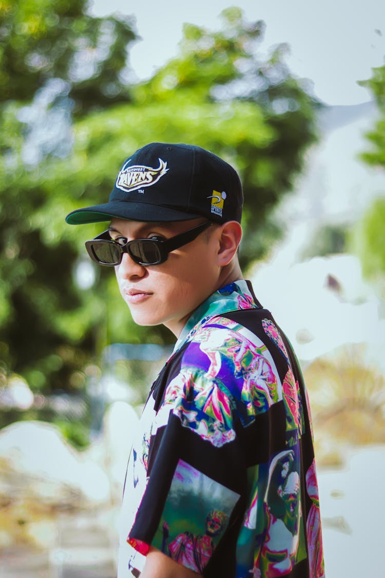 Man In Sunglasses And Hat Posing In Nature