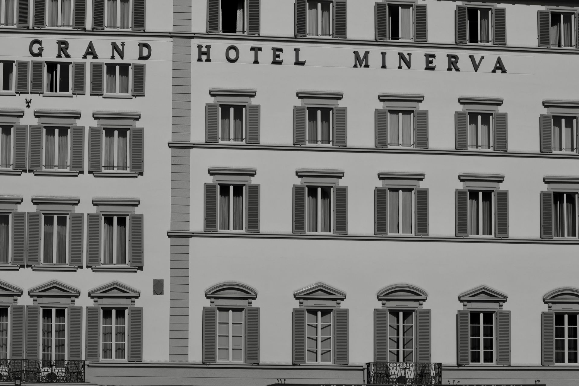 Black and white photo of Grand Hotel Minerva's elegant facade in Florence, Italy.