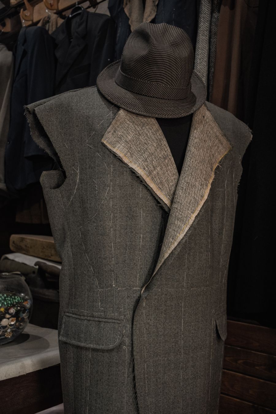 A finished garment on a mannequin in a working studio