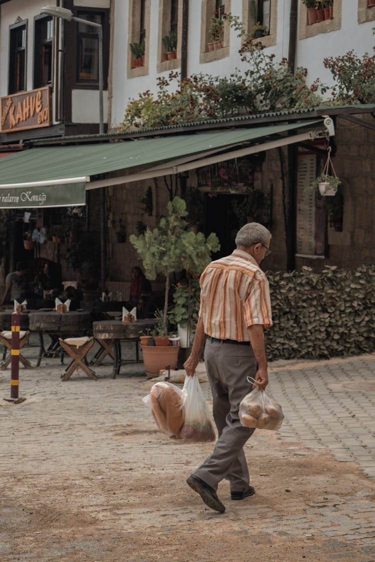 Man In Shirt Carrying Bags