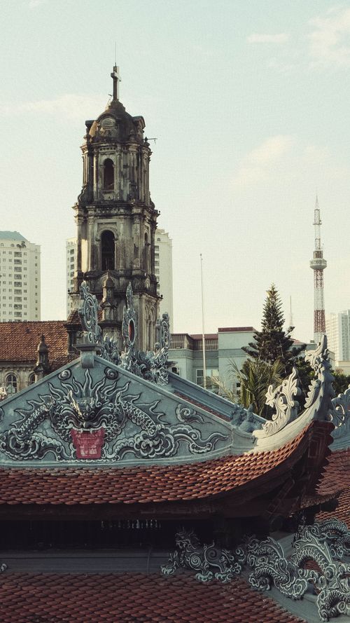Free A beautifully ornate tower with intricate details set against an urban backdrop. Stock Photo