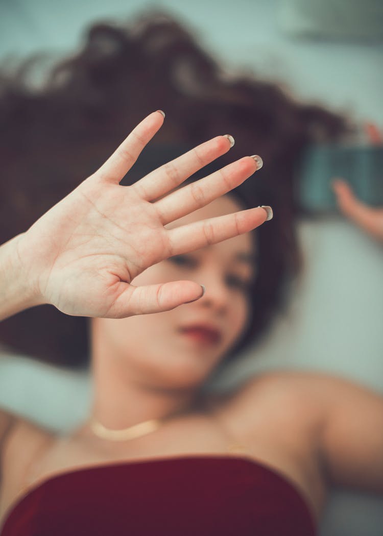 Woman Hand Over Face While Lying Down