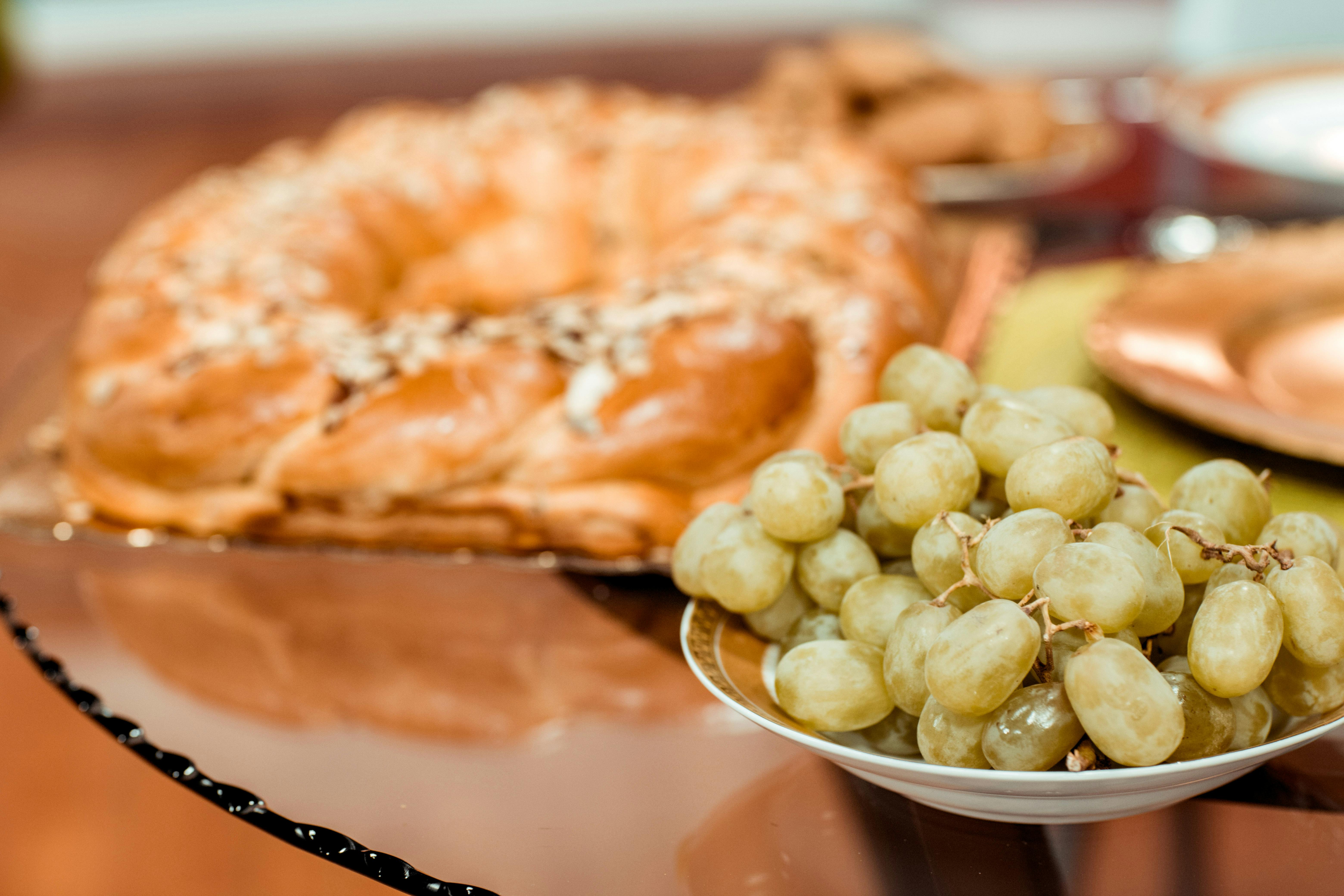 Grapes And Raisins On A Table With A Dog Looking At Them