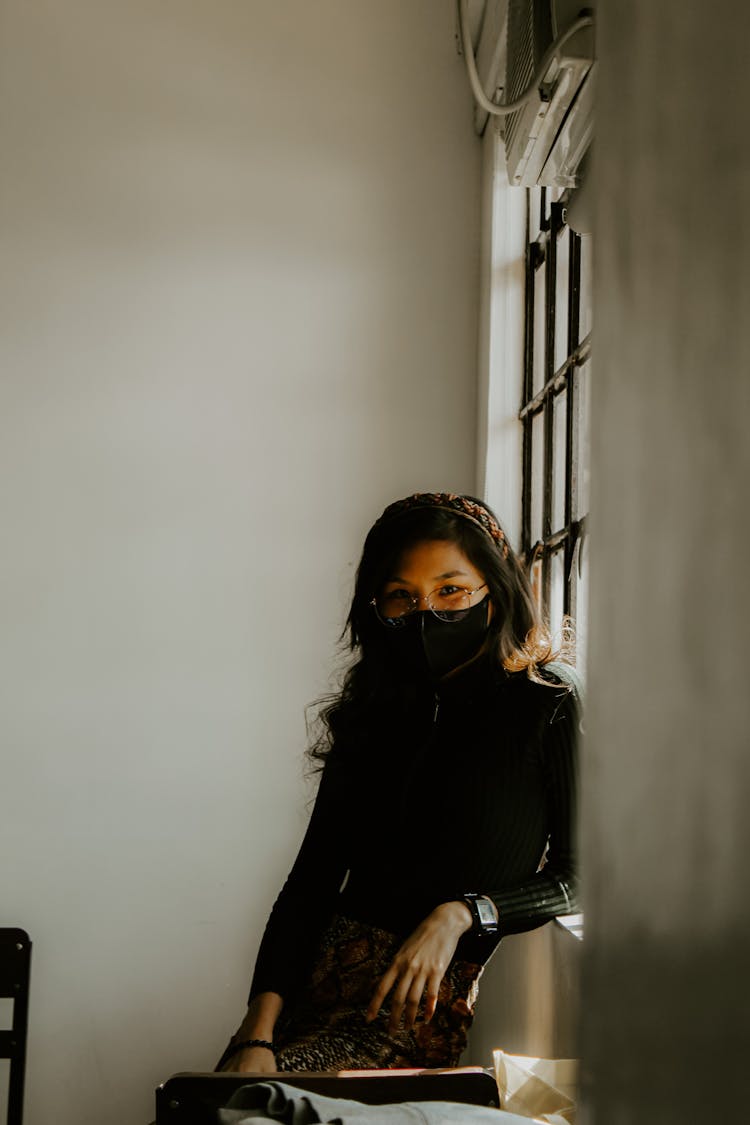 Woman In Mask And Eyeglasses Posing