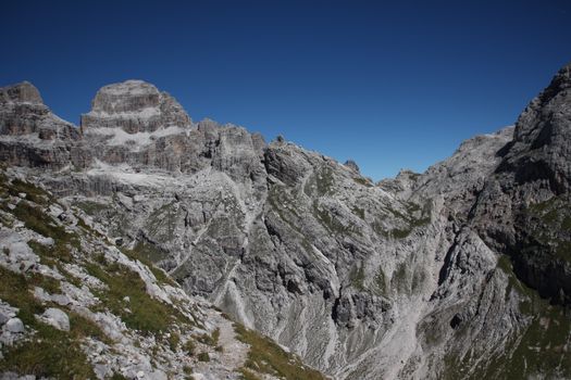 Stunning panorama of the rocky landscape in the Brenta Dolomites under a clear blue sky.
