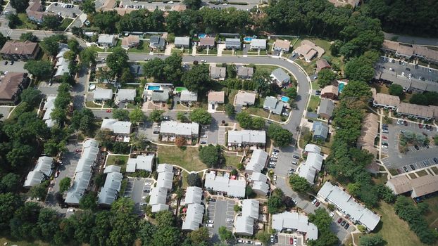 Drone view of a suburban residential area with houses and tree-lined streets in Woodbridge Township, NJ.