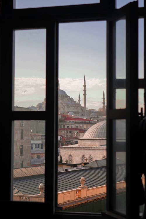 Free Window view of Istanbul with iconic mosque spires and clear sky. Stock Photo