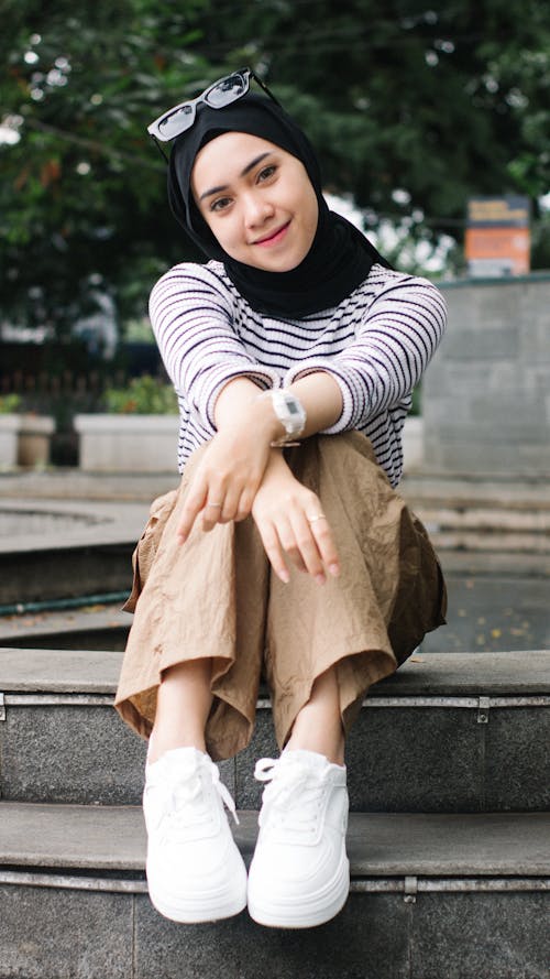 Smiling Woman in Hijab Sitting and Posing