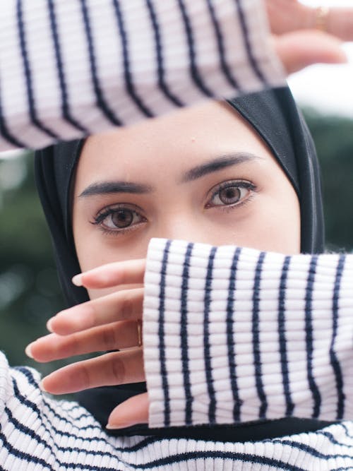 Woman Covering Face with Hands