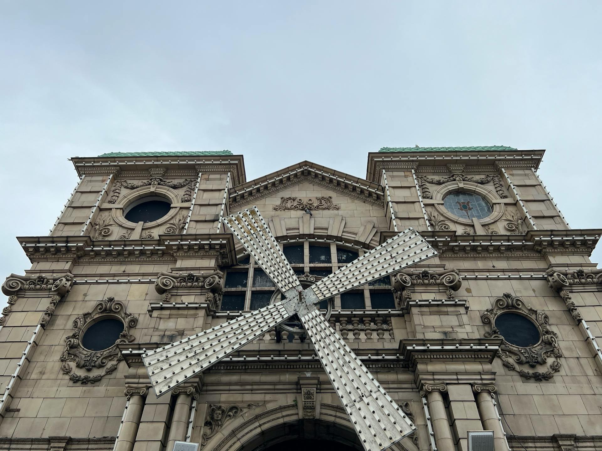 Ornate facade of the Windmill Theatre in Great Yarmouth under an overcast sky, showcasing intricate architecture.