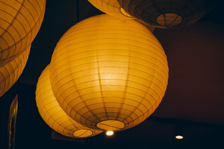 Orange Paper Lanterns Hanging In The Dark