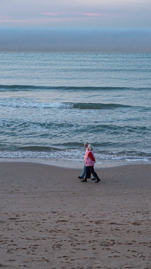 Elderly Couple Walking on Beach