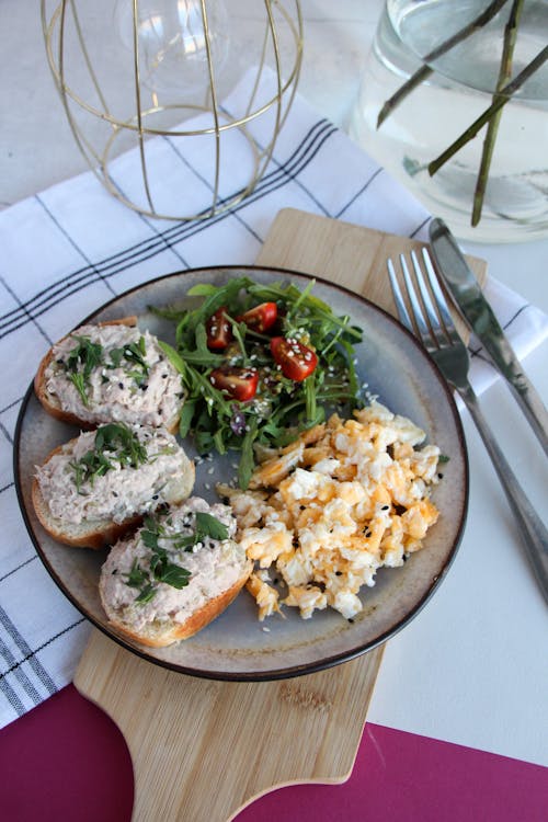 Free Delicious Breakfast with Scrambled Eggs, Arugula Salad and Toasts Stock Photo