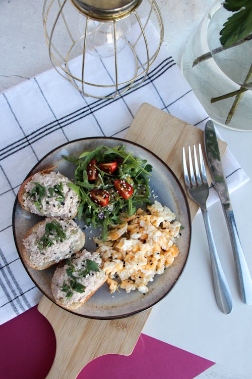 Free Delicious Breakfast with Scrambled Eggs, Arugula Salad and Toasts Stock Photo