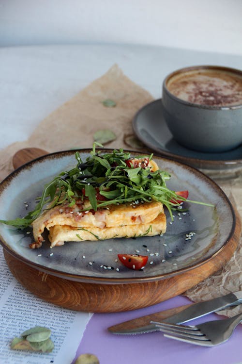 Food on Plate and Coffee Cup behind