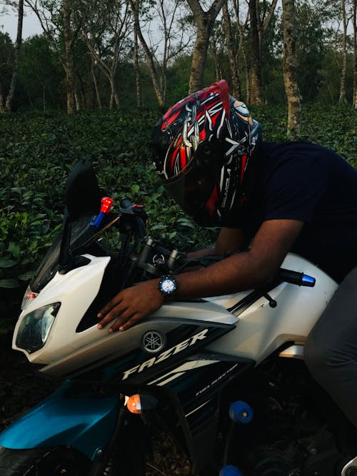 Man in a Helmet Sitting on a Motorcycle 