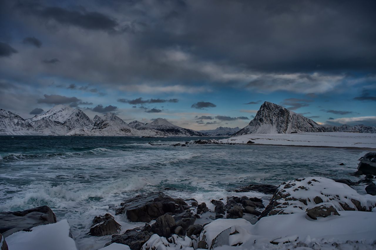 stunning winter landscape of snow capped mountains and the sea in lofo