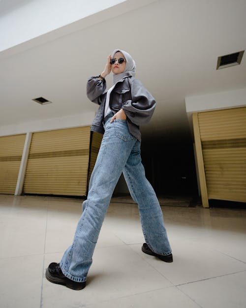 Woman with Sunglasses in Jacket and Jeans