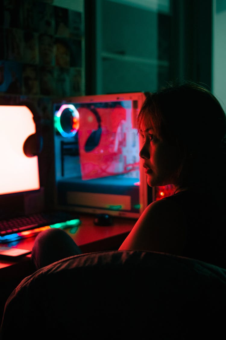 Beautiful Woman Sitting By Computer Setup On Desk