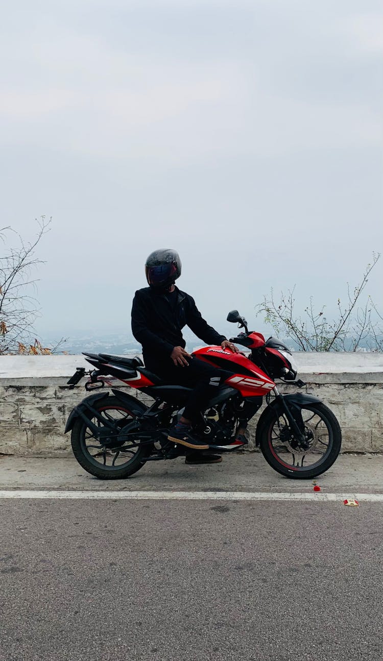 Man On A Motorcycle On The Roadside 