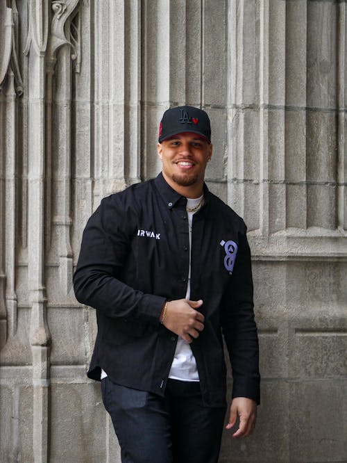 Man Posing in Cap and Jacket 