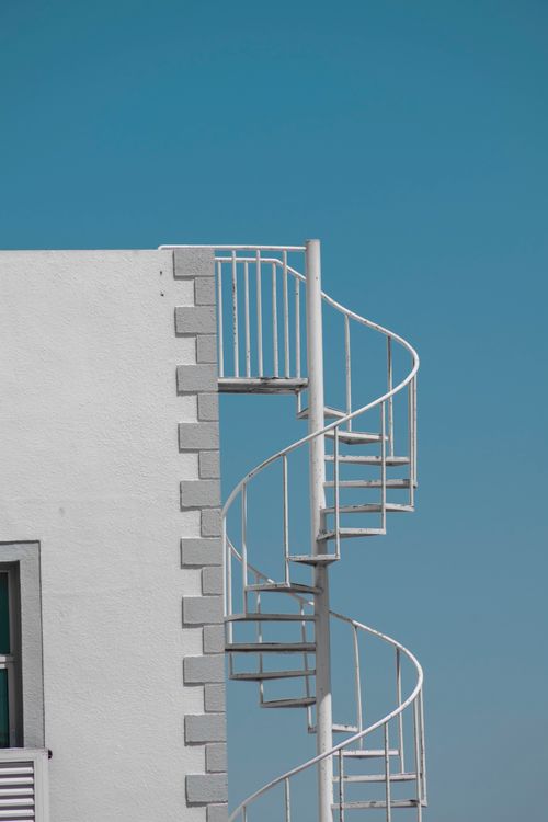 Free Minimalist view of a white spiral staircase on a building in Dubai, UAE. Stock Photo