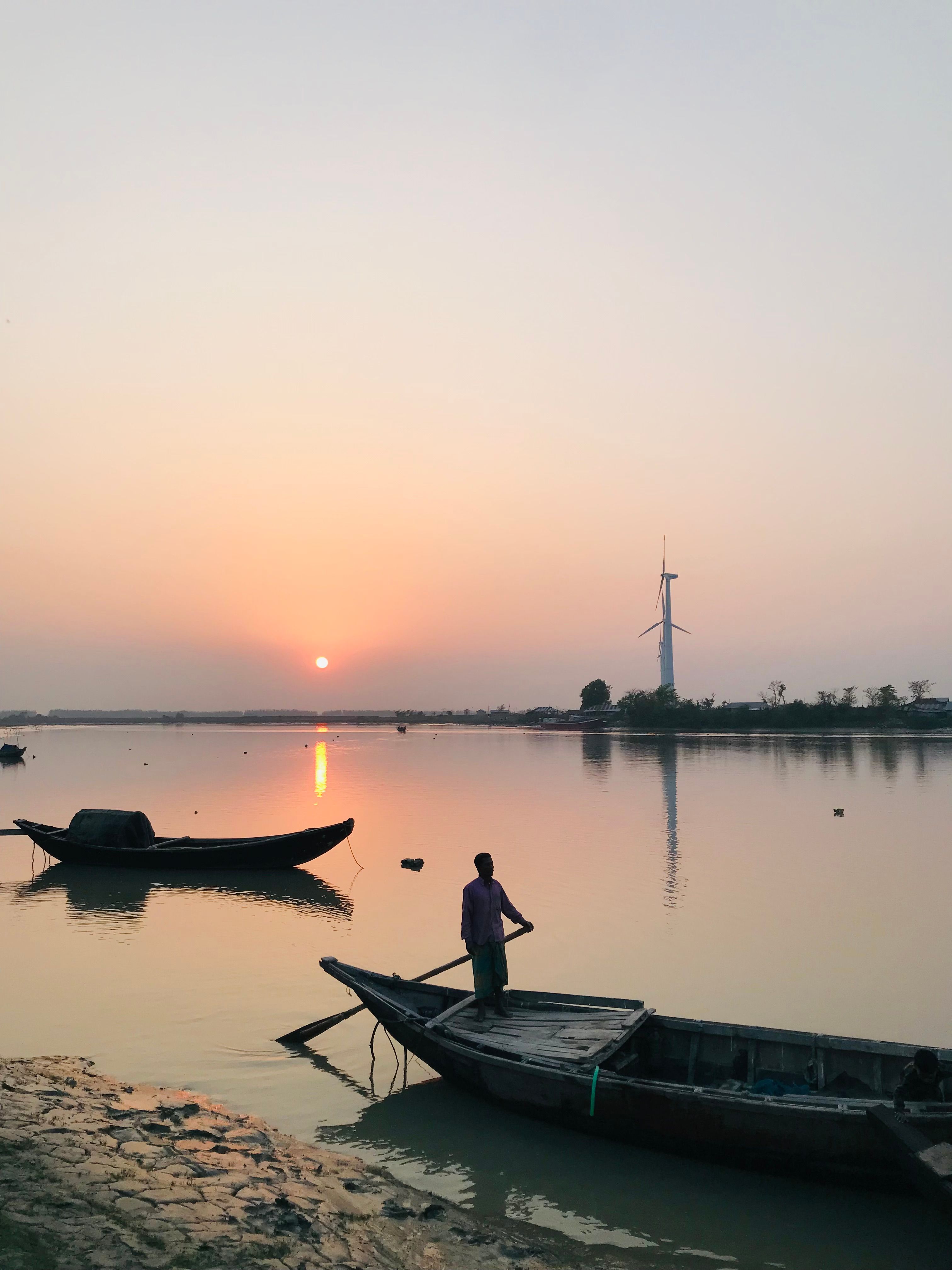Fisherman on Boat at Sunset · Free Stock Photo