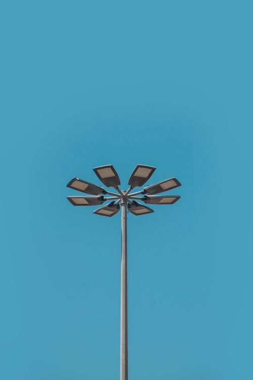 Free A modern street lamp with multiple lights against a clear blue sky in Dubai. Stock Photo