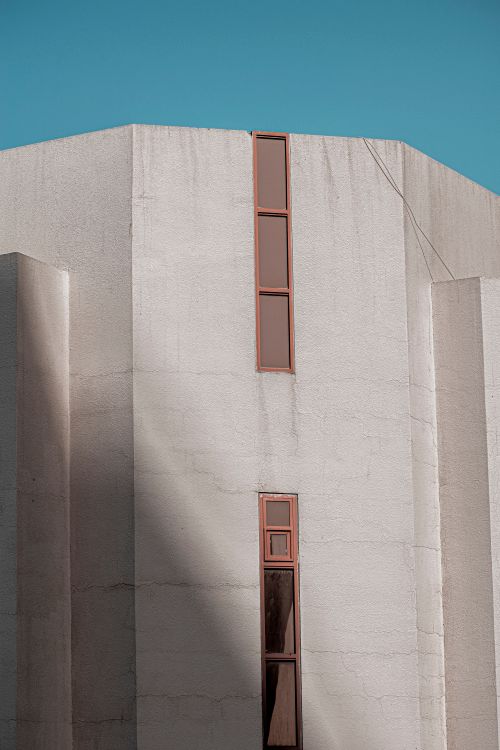 Free A minimalist architectural building with vertical windows against a clear sky in Dubai. Stock Photo