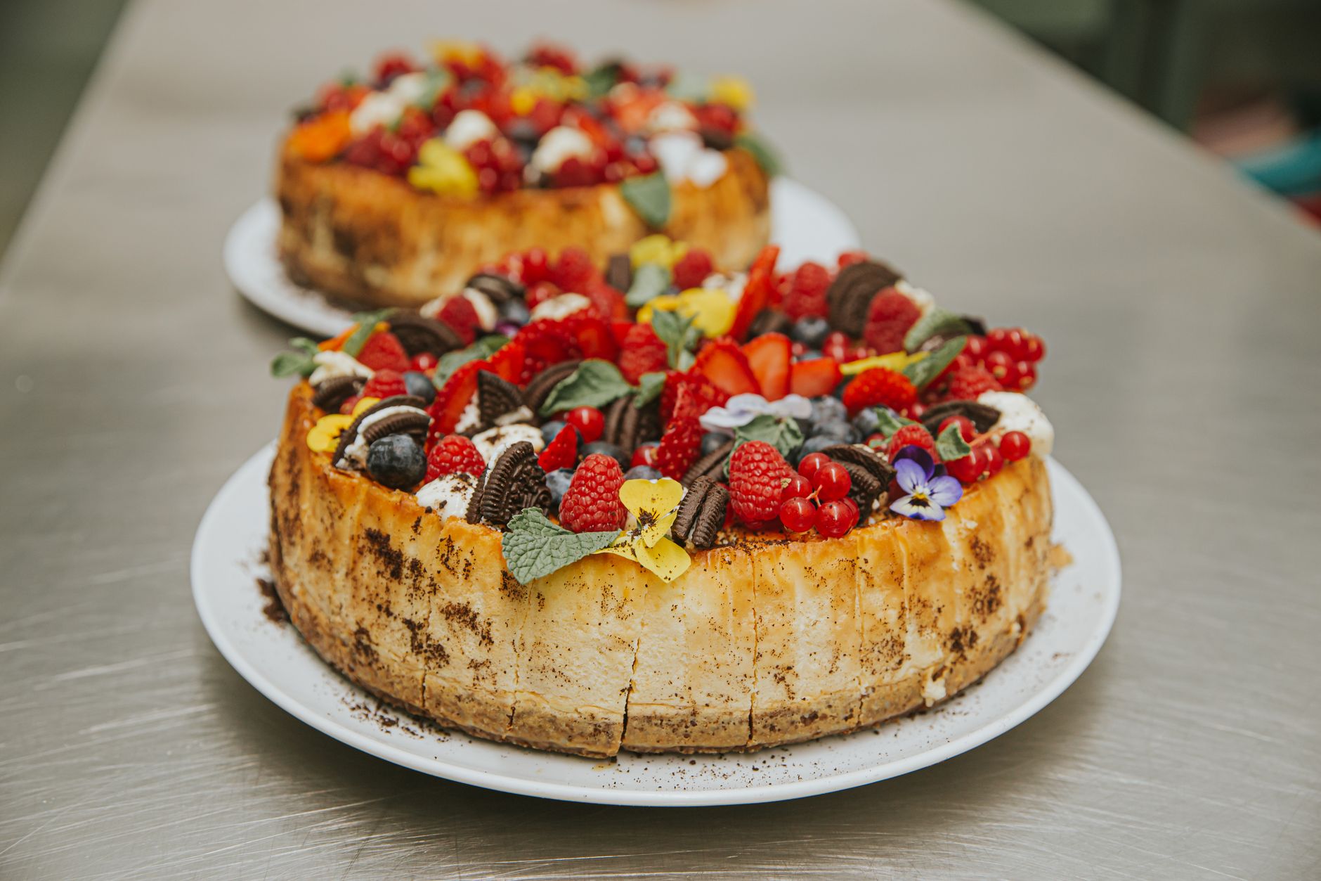 Slice of blueberry cheesecake with fresh berries on top