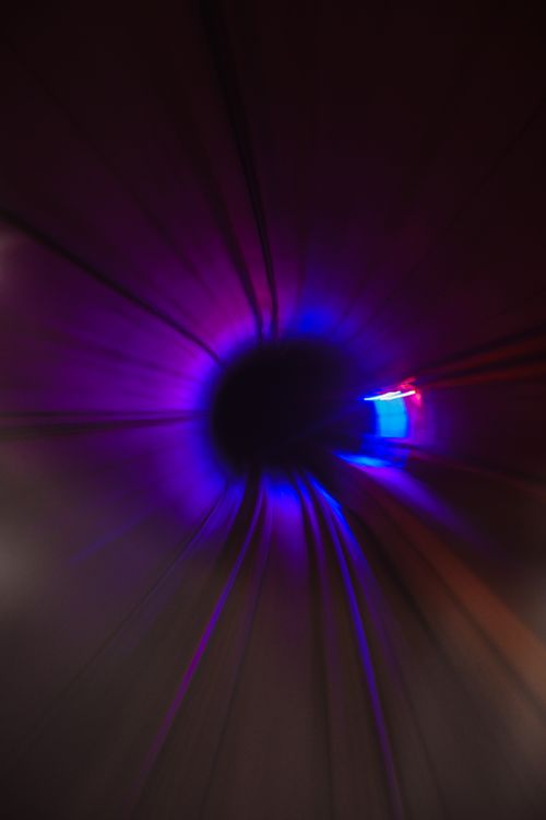 Free Abstract view of a colorful tunnel with dynamic lighting effects. Stock Photo
