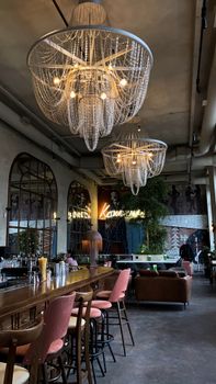 Stylish cafe interior in Kharkiv featuring elegant chandeliers and cozy seating.