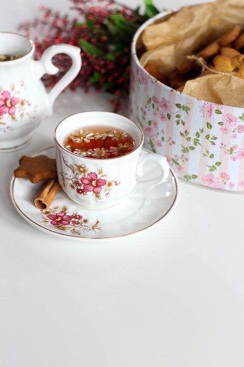 Free Elegant floral tea set with cookies and cinnamon, perfect for cozy indoor tea time. Stock Photo