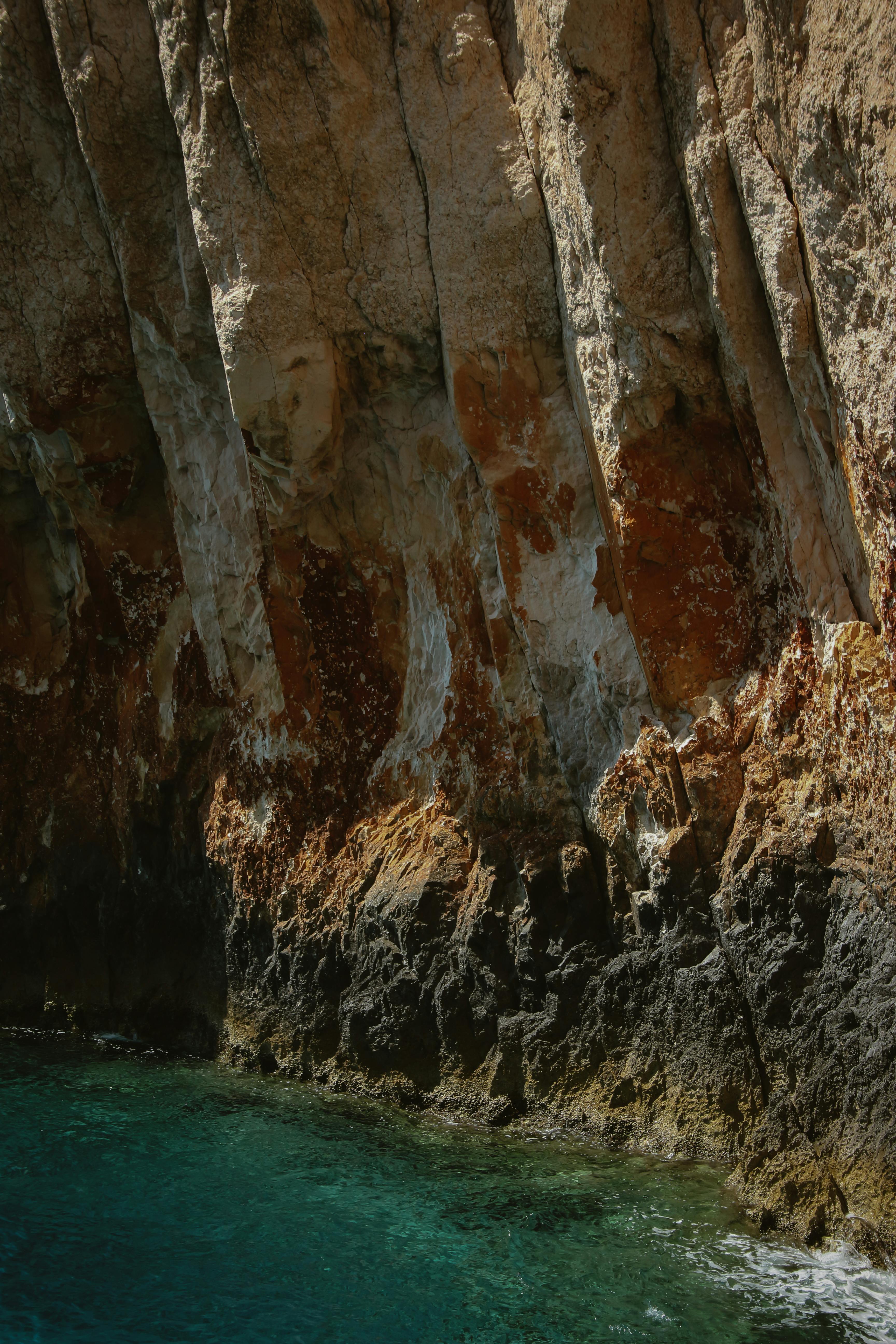 Majestic rocky cliffs rising above the clear sea in Zakynthos, Greece.