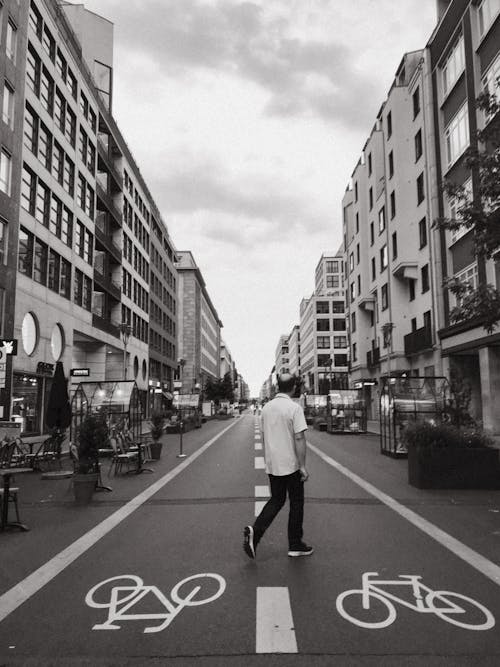Man Crossing Bike Road in City