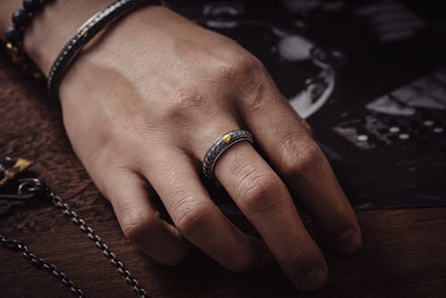 Hand of a Person Wearing a Ring