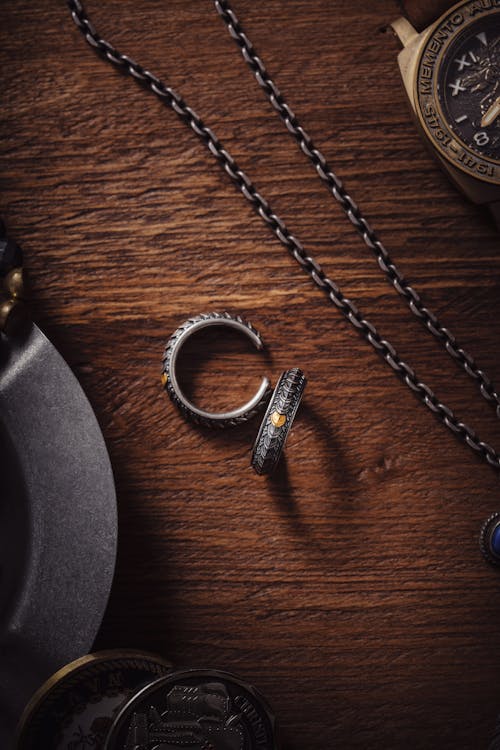 Silver Ring and Chain on a Table 