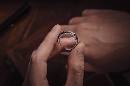 Woman Holding a Silver Ring 