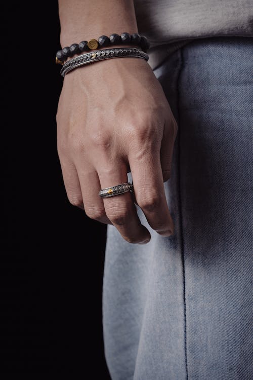 Hand of a Person Wearing Bracelets and a Ring