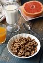 Chocolate Cereal on White Bowl Near Glass of Milk