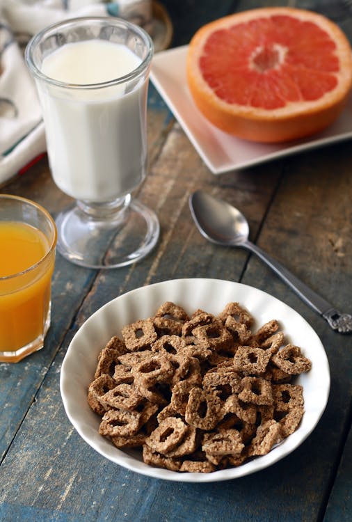 Free Chocolate Cereal on White Bowl Near Glass of Milk Stock Photo