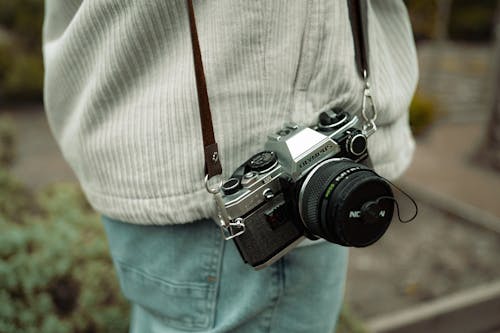 Close-up of Retro Camera Hanging on Person Shoulder