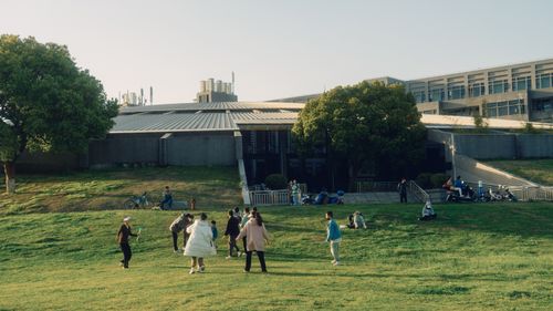 Free Families enjoy outdoor activities on a sunny day in a city park. Stock Photo